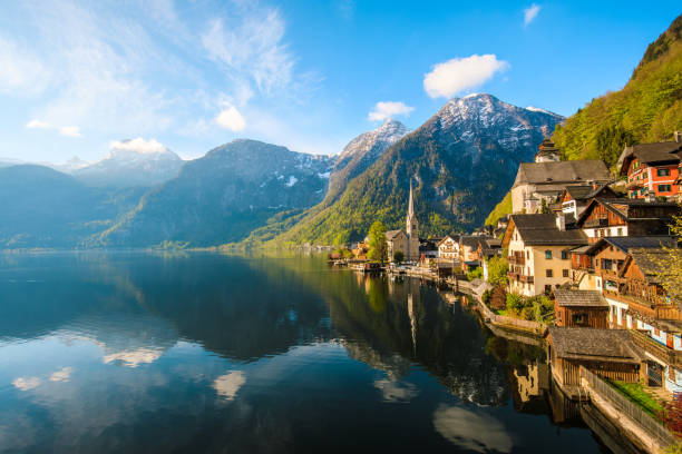 Beautiful alpine village by a lake with mountains in the background